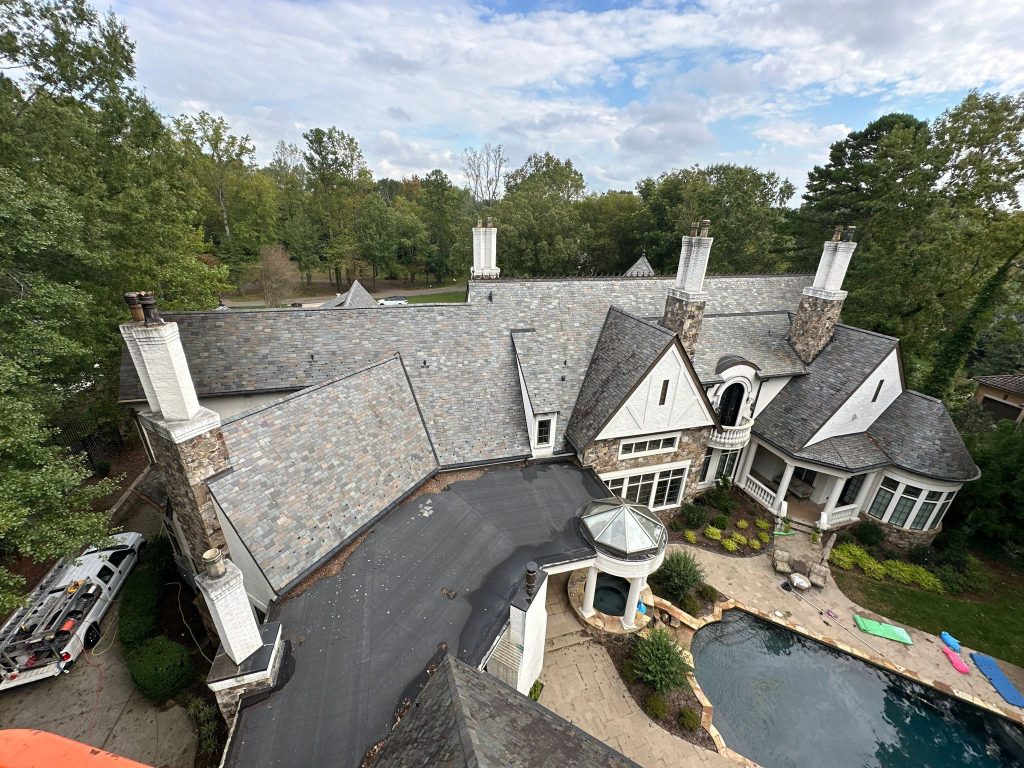Aerial photo of luxury home's clean roof done by Charlotte Exterior Services, a roof washing company in Charlotte NC